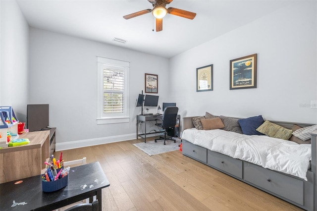 bedroom featuring visible vents, ceiling fan, baseboards, and wood-type flooring