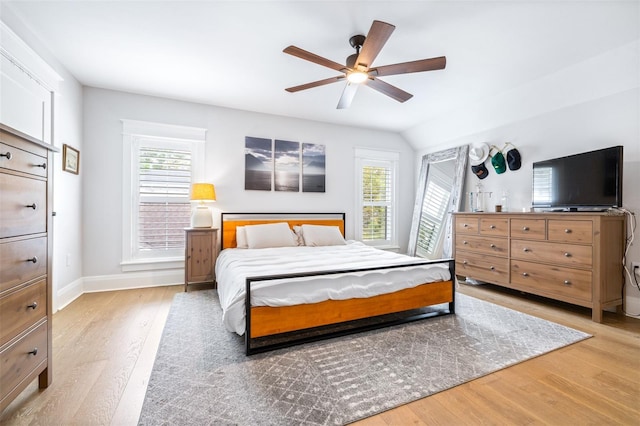 bedroom with baseboards, a ceiling fan, and light wood finished floors