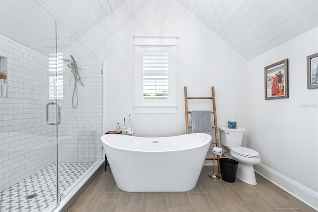 full bathroom featuring a shower stall, toilet, lofted ceiling, tile patterned floors, and a soaking tub