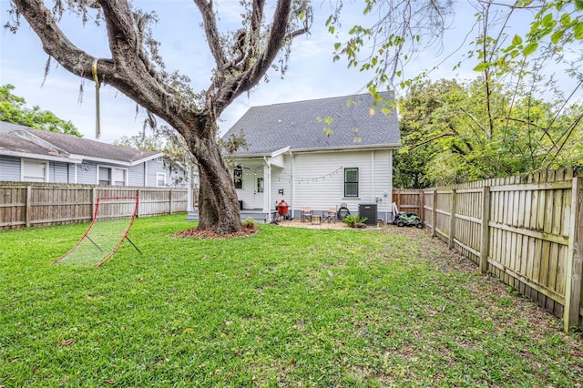 rear view of property featuring central air condition unit, a lawn, a fenced backyard, and roof with shingles