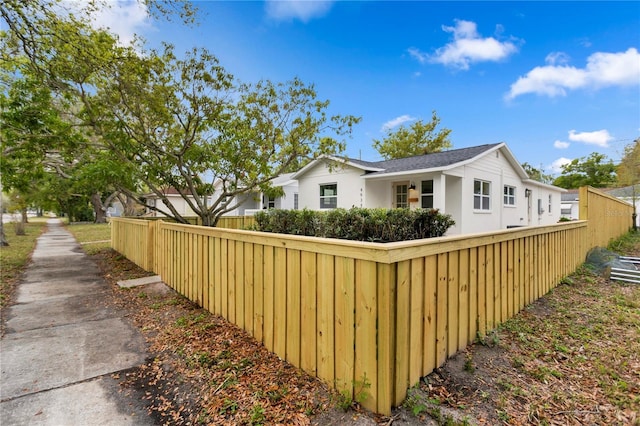 view of side of home featuring fence