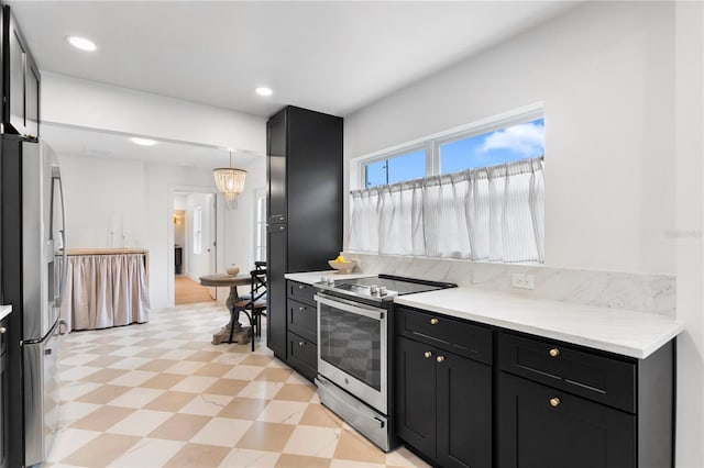 kitchen featuring light floors, recessed lighting, stainless steel appliances, light countertops, and dark cabinets