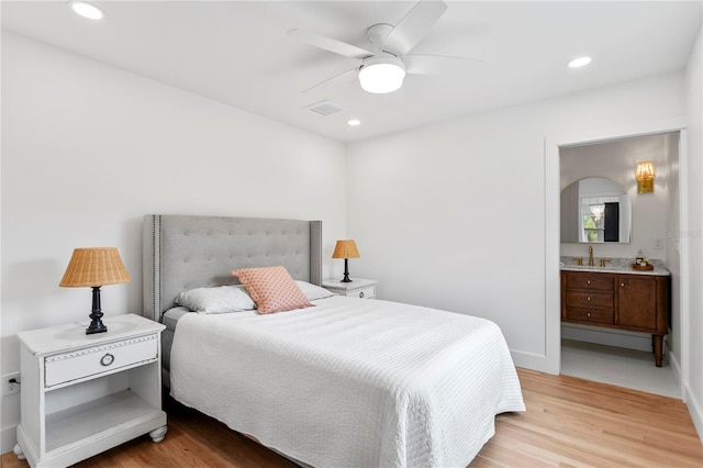 bedroom with recessed lighting, light wood-style floors, visible vents, and ensuite bathroom