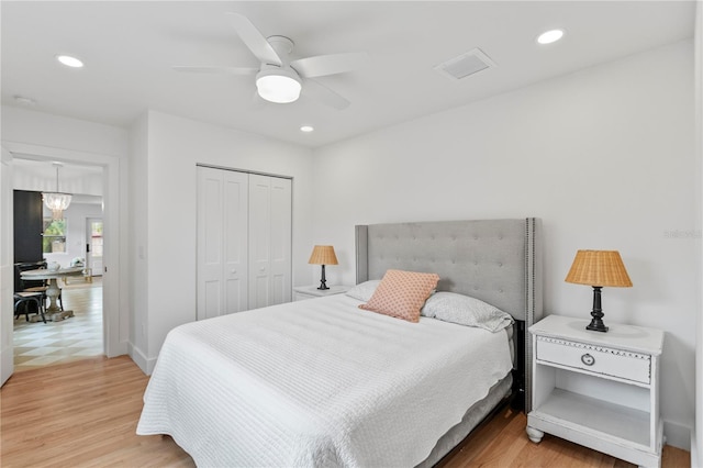 bedroom with a closet, visible vents, recessed lighting, and light wood-style floors