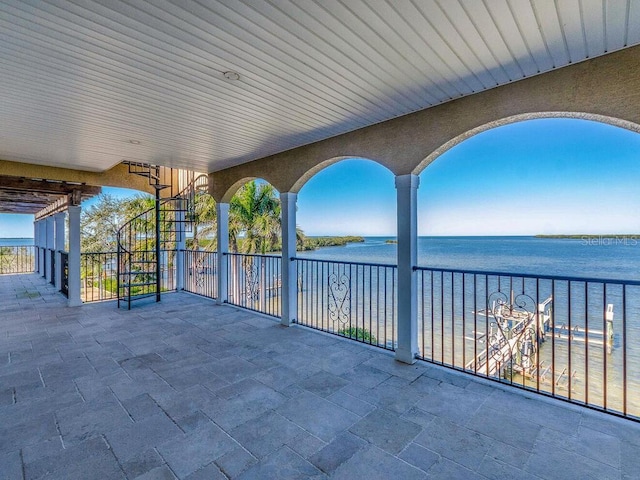 view of patio / terrace featuring a balcony and a water view