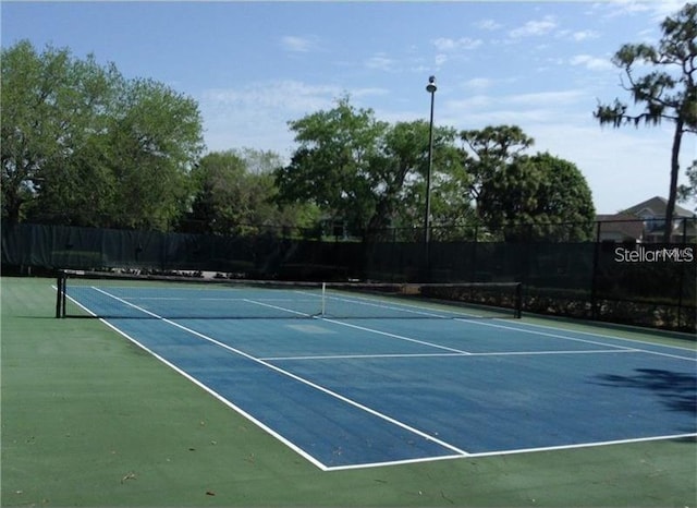 view of sport court with fence