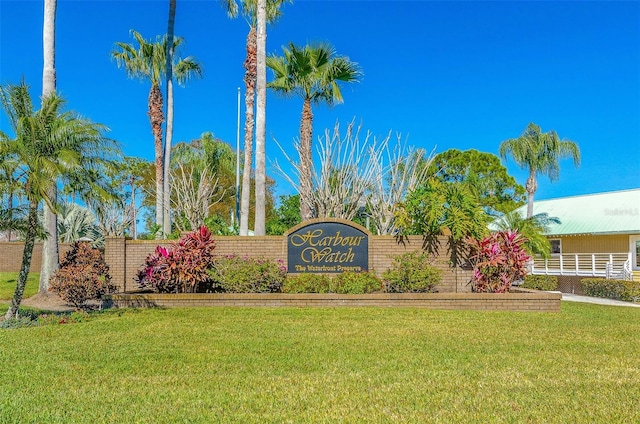 community / neighborhood sign with a lawn