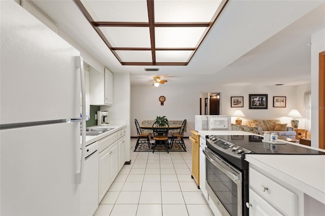 kitchen with white appliances, visible vents, light tile patterned flooring, white cabinetry, and open floor plan