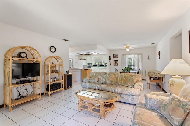 living room featuring ceiling fan and light tile patterned flooring