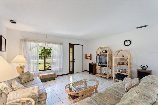 tiled living room with visible vents and baseboards