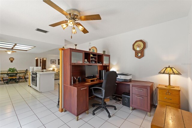 office featuring light tile patterned flooring, visible vents, and a ceiling fan