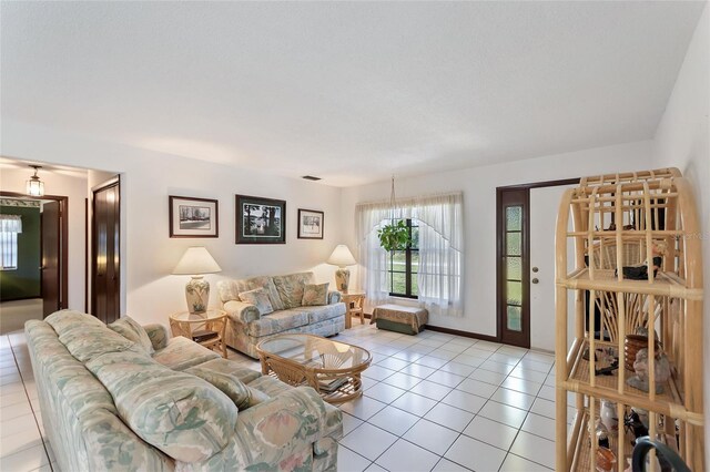 living room with tile patterned floors and baseboards