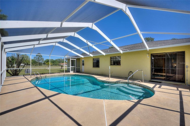 pool featuring glass enclosure and a patio