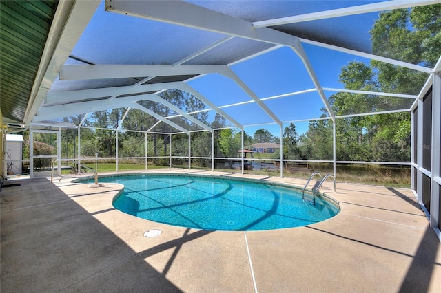 outdoor pool with glass enclosure and a patio