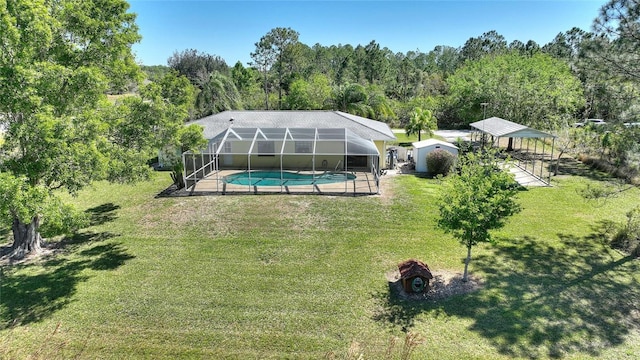 outdoor pool with a patio, a lanai, a lawn, and a view of trees