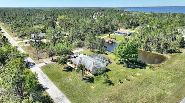 aerial view featuring a view of trees and a water view