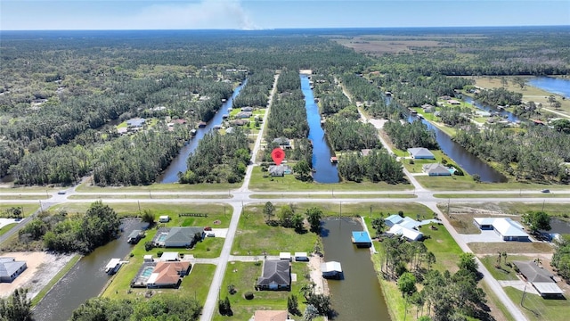 bird's eye view with a wooded view and a water view