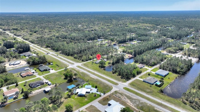 bird's eye view featuring a forest view and a water view