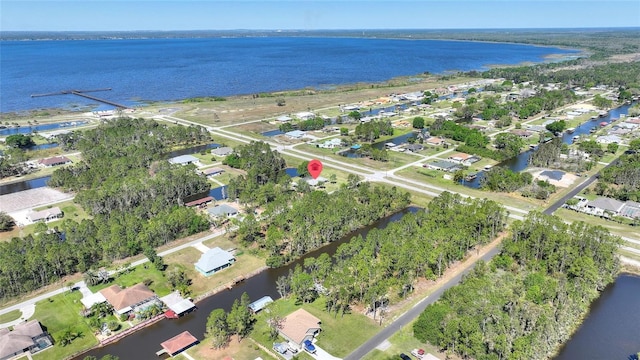 drone / aerial view featuring a residential view and a water view