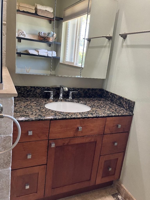 bathroom with vanity and baseboards