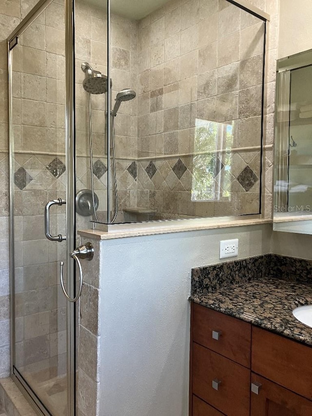 full bathroom featuring a shower stall and vanity