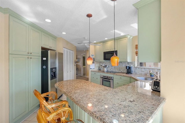 kitchen with black appliances, a sink, backsplash, a peninsula, and light tile patterned floors