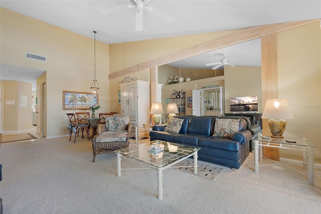 living area with baseboards, visible vents, high vaulted ceiling, ceiling fan, and carpet flooring