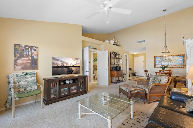 carpeted living room with visible vents, high vaulted ceiling, and a ceiling fan