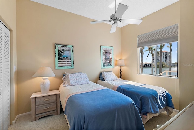 bedroom with baseboards, light colored carpet, and ceiling fan