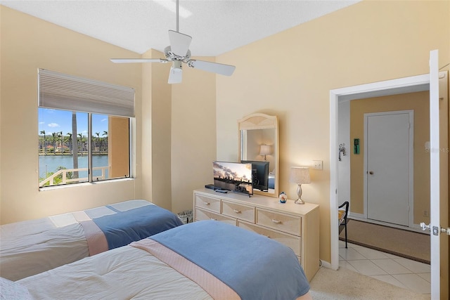 bedroom with a ceiling fan, light colored carpet, and baseboards