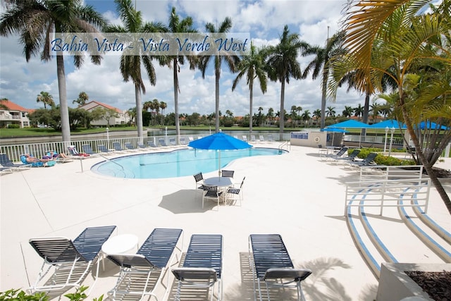 community pool featuring a patio area and fence