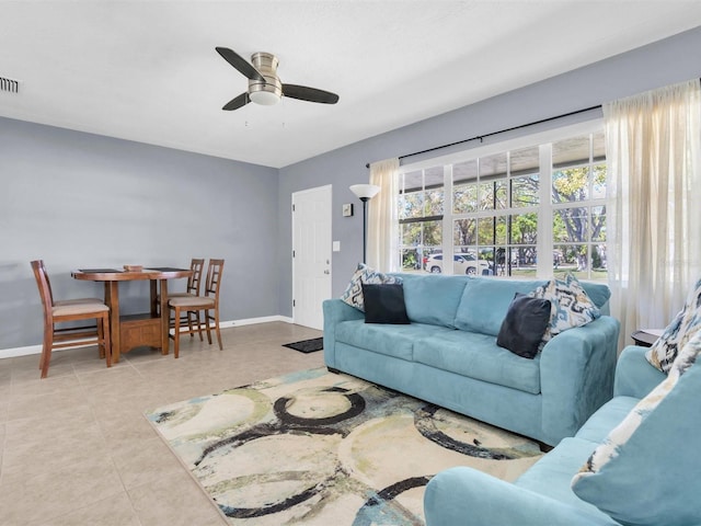 living room featuring visible vents, baseboards, ceiling fan, and tile patterned flooring