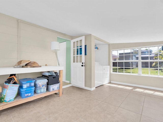 foyer featuring washer and dryer, baseboards, and tile patterned floors