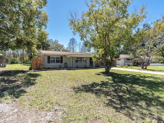 ranch-style home with a front yard and driveway