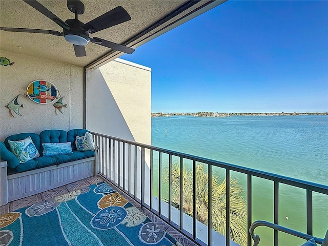 balcony featuring a ceiling fan and a water view