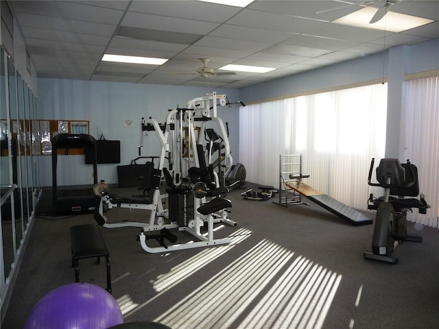 gym with a drop ceiling and ceiling fan