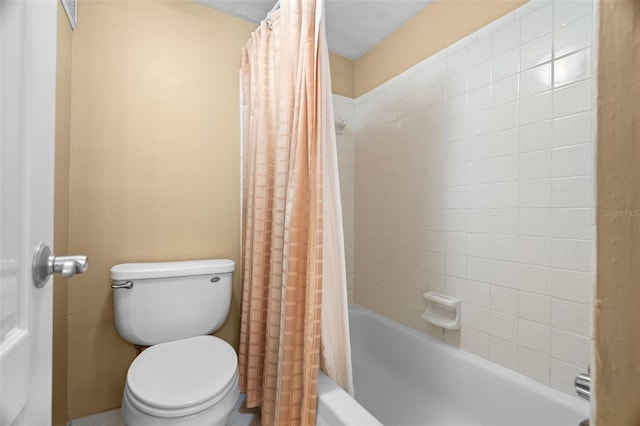 bathroom with toilet and shower / tub combo