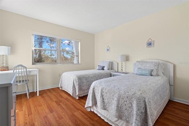 bedroom featuring baseboards and light wood-type flooring