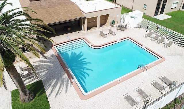 pool with a patio and a fenced backyard