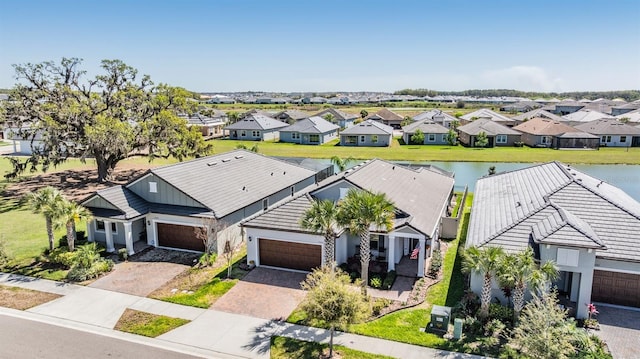 drone / aerial view with a residential view and a water view