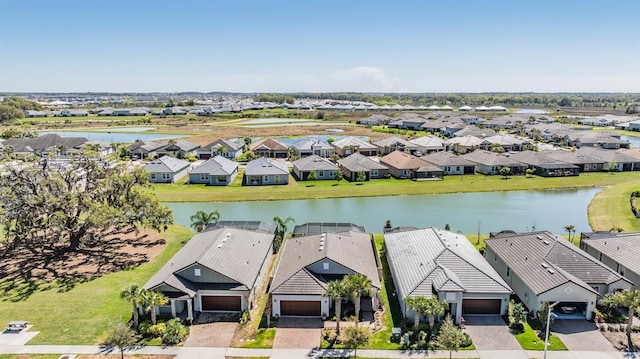 birds eye view of property with a residential view and a water view