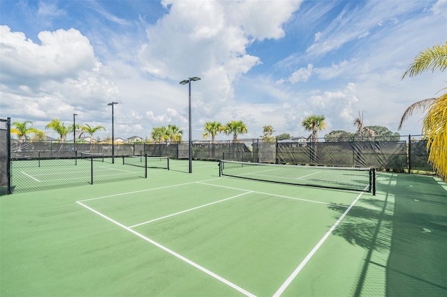 view of tennis court with fence