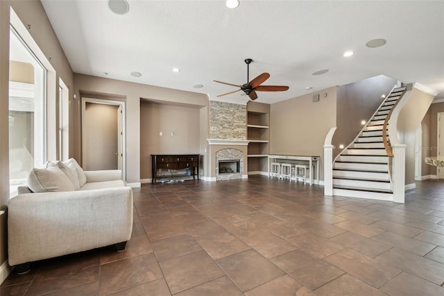 living room featuring ceiling fan, baseboards, built in features, and recessed lighting