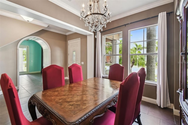 dining space with arched walkways, tile patterned flooring, a notable chandelier, and plenty of natural light