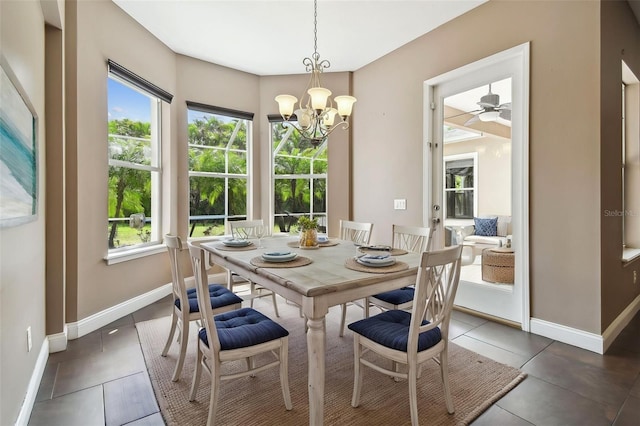 tiled dining area with a wealth of natural light, an inviting chandelier, and baseboards
