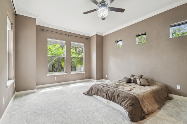 bedroom with carpet, crown molding, baseboards, and a ceiling fan