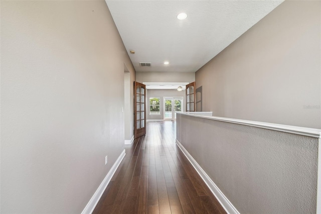 corridor with baseboards, visible vents, recessed lighting, and dark wood-style flooring