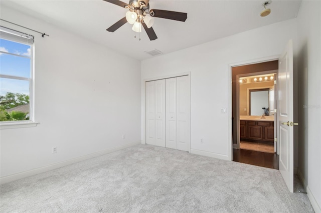 unfurnished bedroom with dark colored carpet, visible vents, a closet, baseboards, and ceiling fan