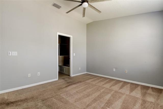 unfurnished room featuring visible vents, baseboards, ceiling fan, vaulted ceiling, and light carpet