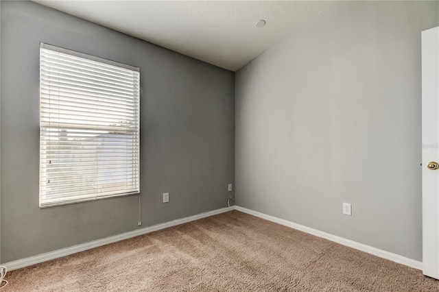 carpeted empty room with baseboards